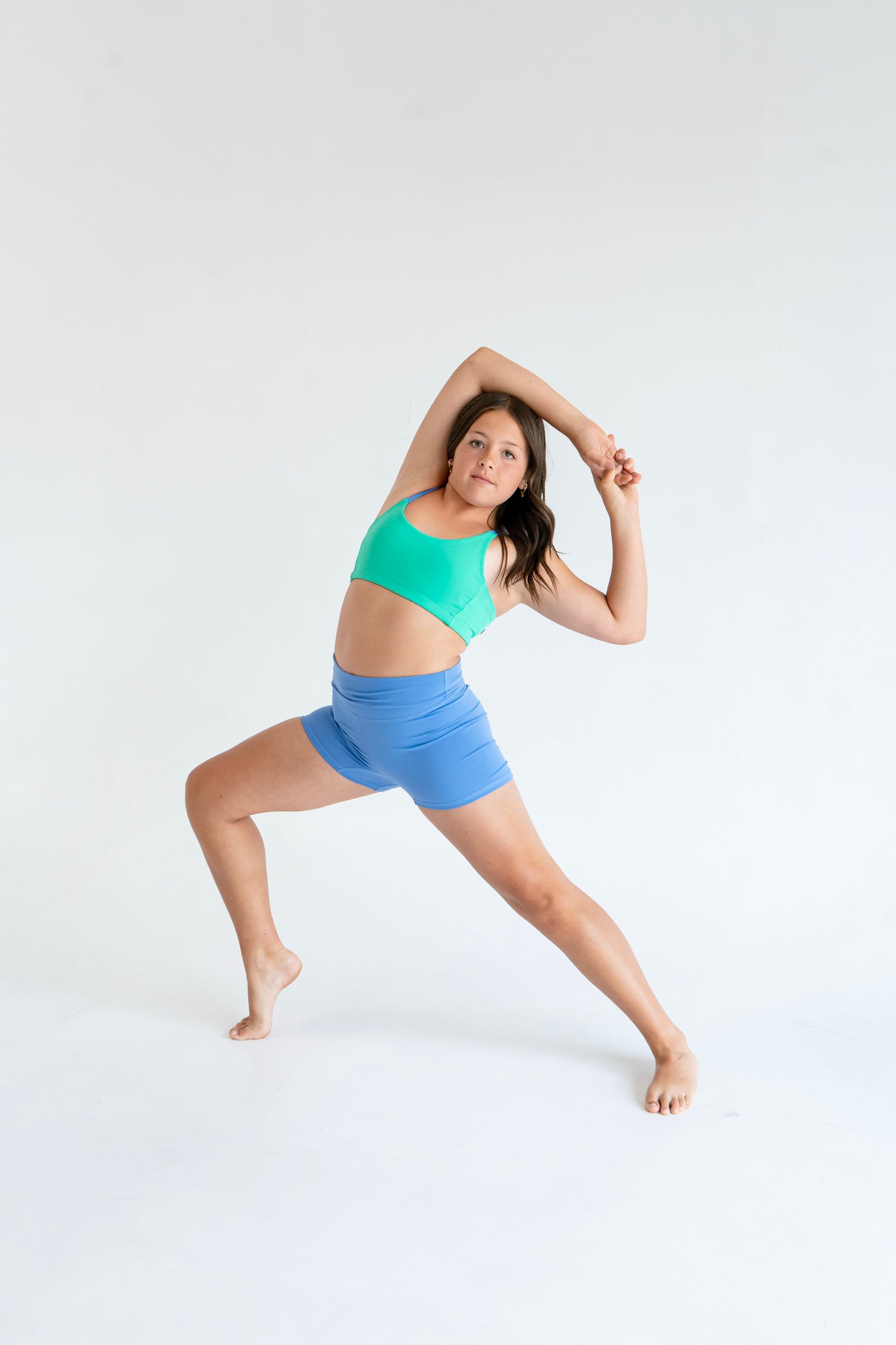 Girl in Laguna Green / Newport Blue asymmetrical dance top | Pivot Dancewear