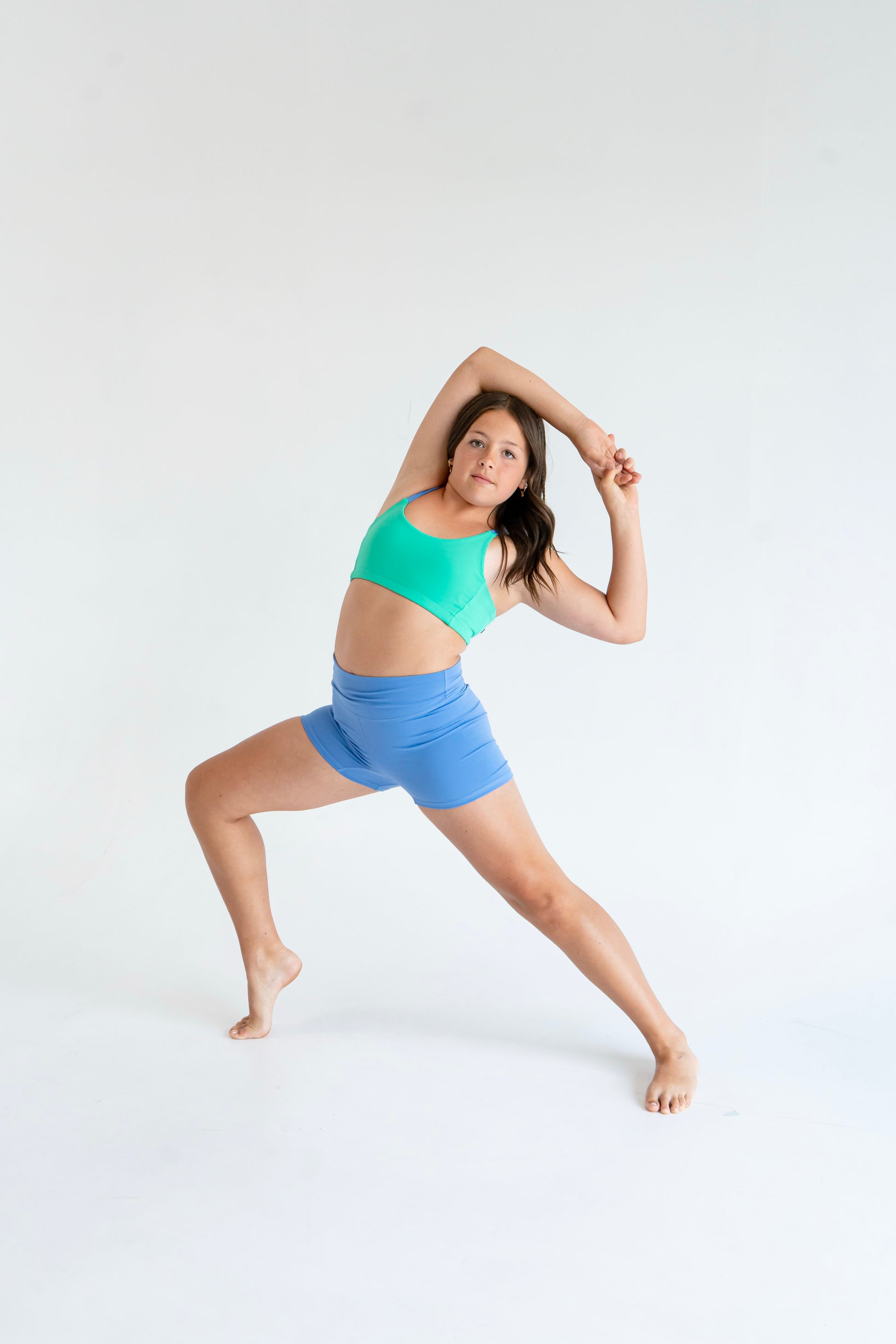 Girl in Laguna Green / Newport Blue asymmetrical dance top | Pivot Dancewear